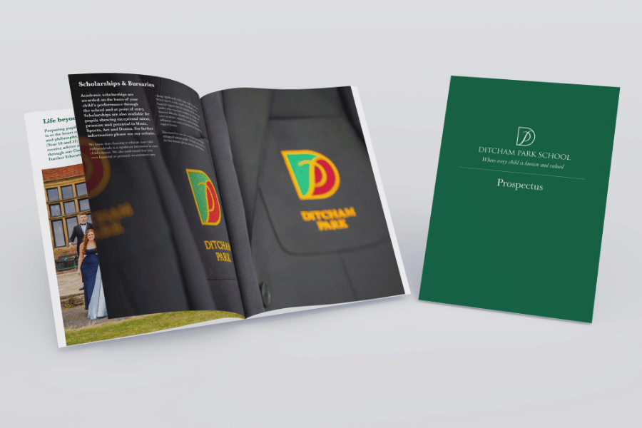 An open spread on Ditcham Park School's prospectus next to the prospectus folder.