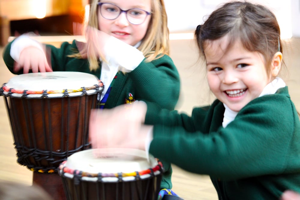 School children playing bongos